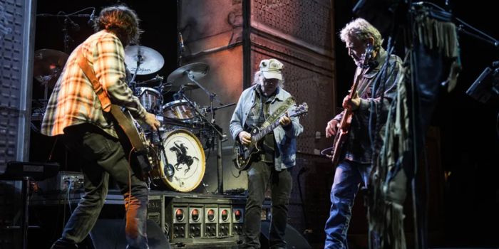 neil young and crazy horse performing live during the love earth tour